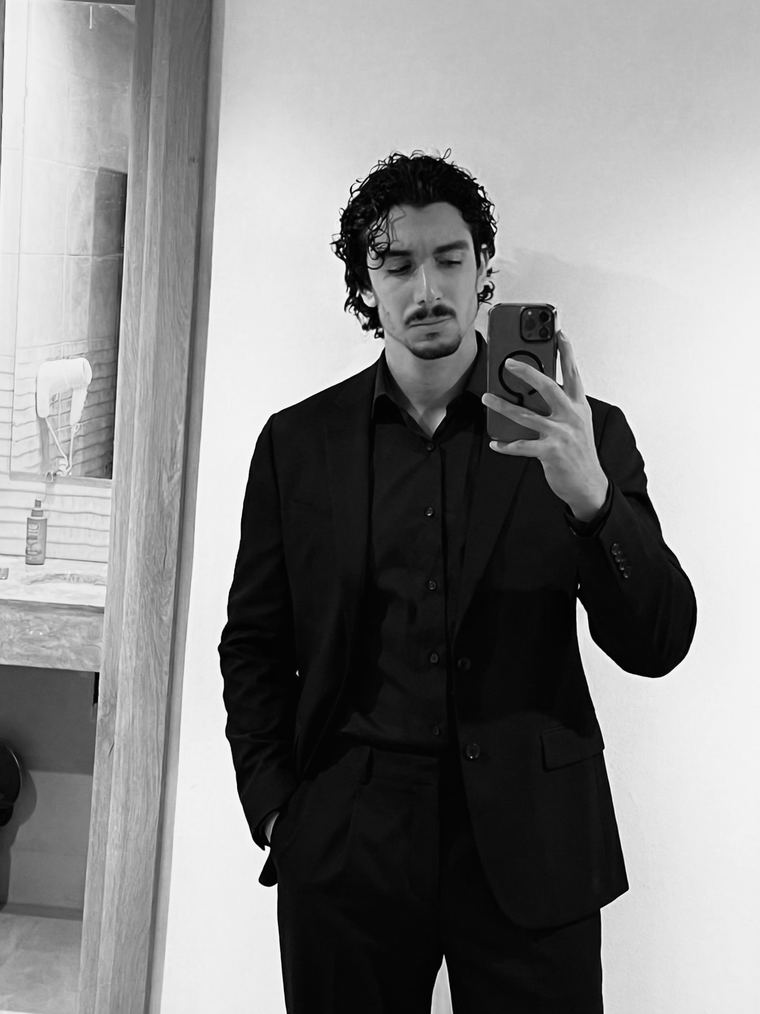 Hazem Telmoudi in a black suit, black and white